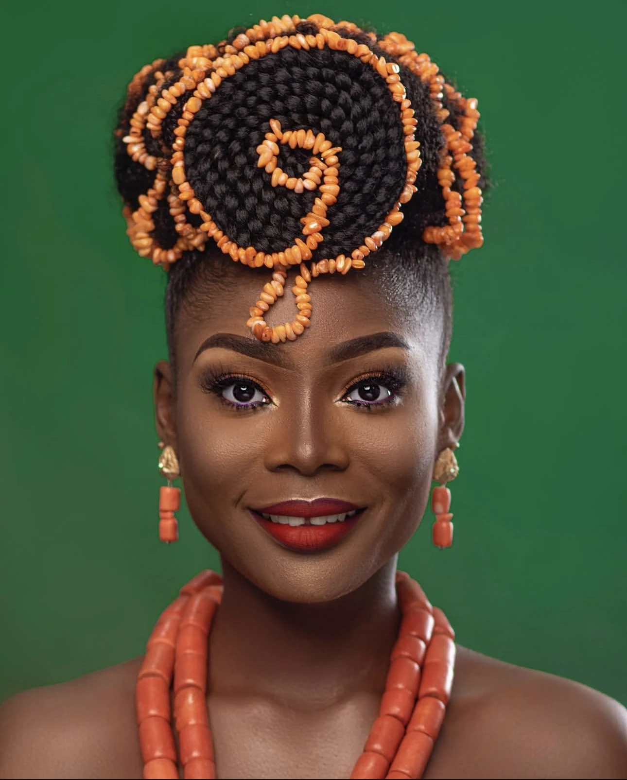 Coiled braids finished with coral-coloured beads, styled by Unique Hair Affairs