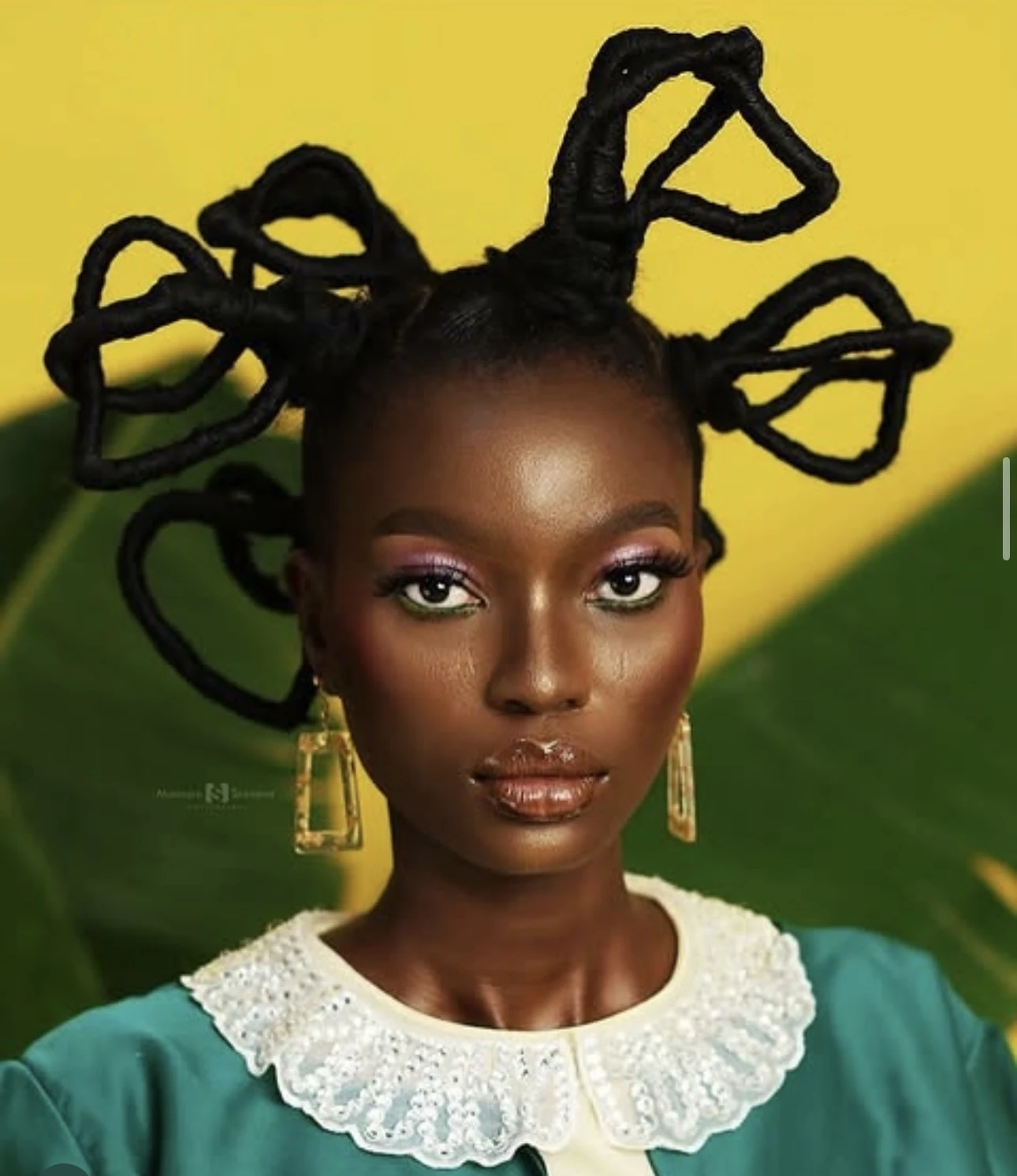 Sculptural braided hair arranged in expressive loops, styled by Unique Hair Affairs